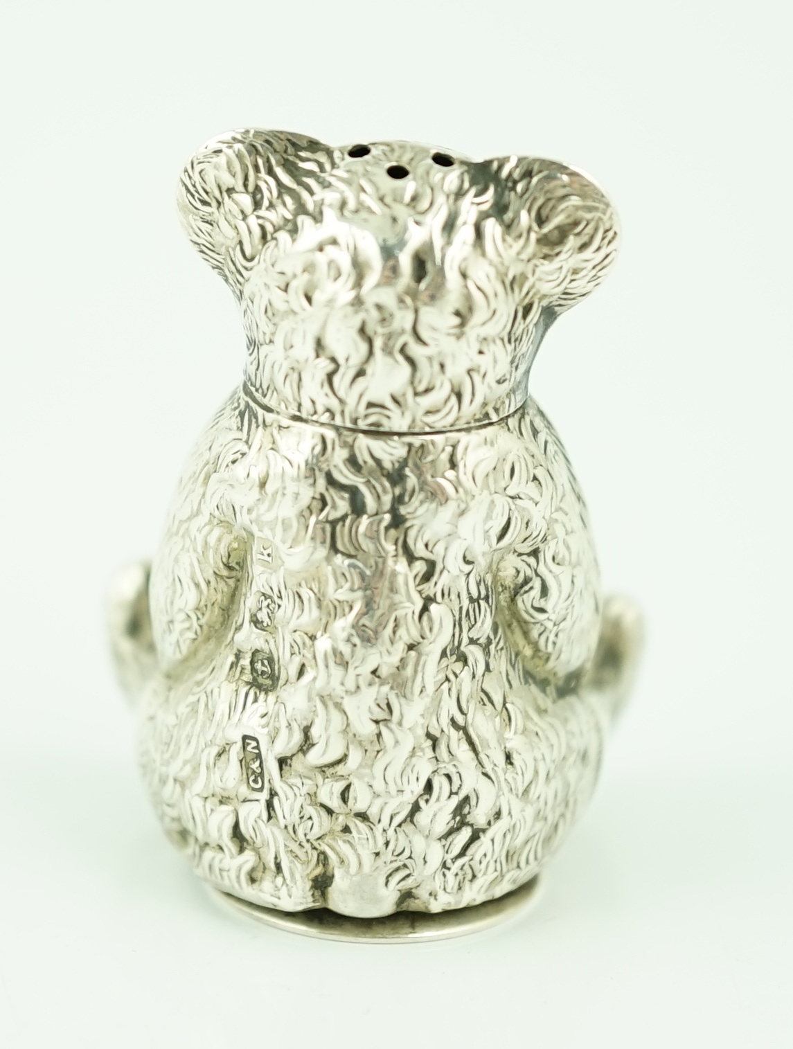 An Edwardian novelty silver pepperette modelled as a seated bear, Crisford & Norris